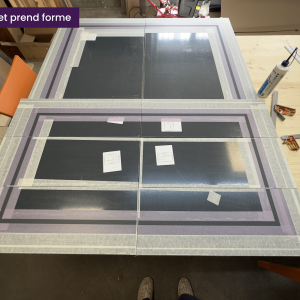 Alignement précis de plusieurs façades de tiroirs en atelier, masquage en cours pour la peinture